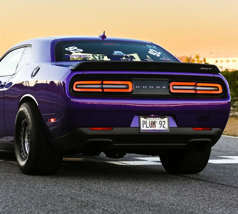 Purple Dodge Challenger SRT equipped with an upgraded suspension.