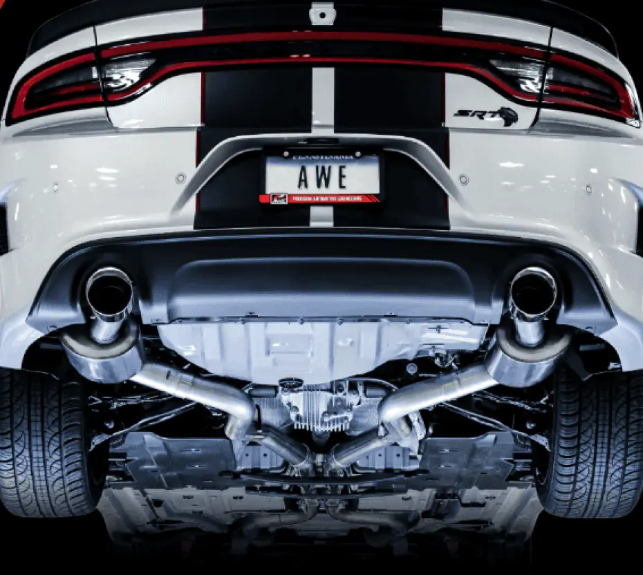 Car on a mechanic lift, showing the underbelly and exhaust system.