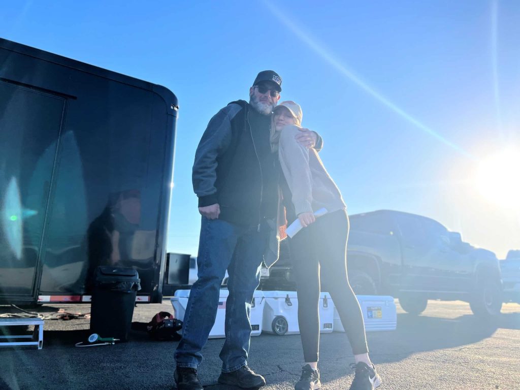 man and daughter at drag race