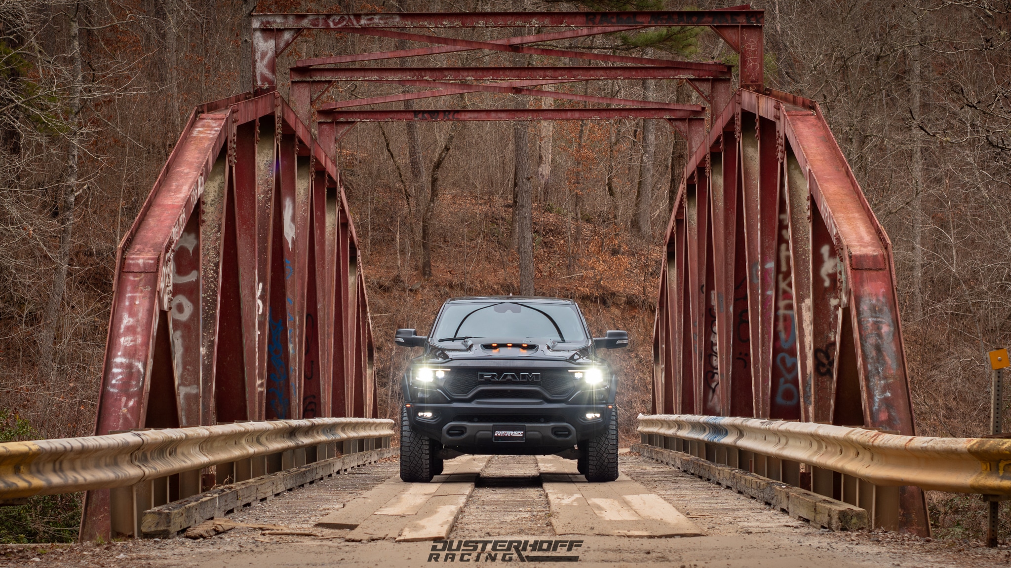 black Dodge Ram TRX on a old rustic bridge