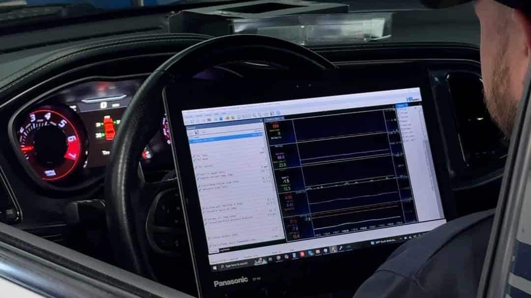 man tuning a dodge charger / challenger